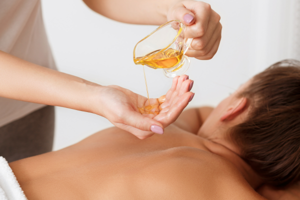 Hot oil massage to soothe muscles, improve circulation, and hydrate skin